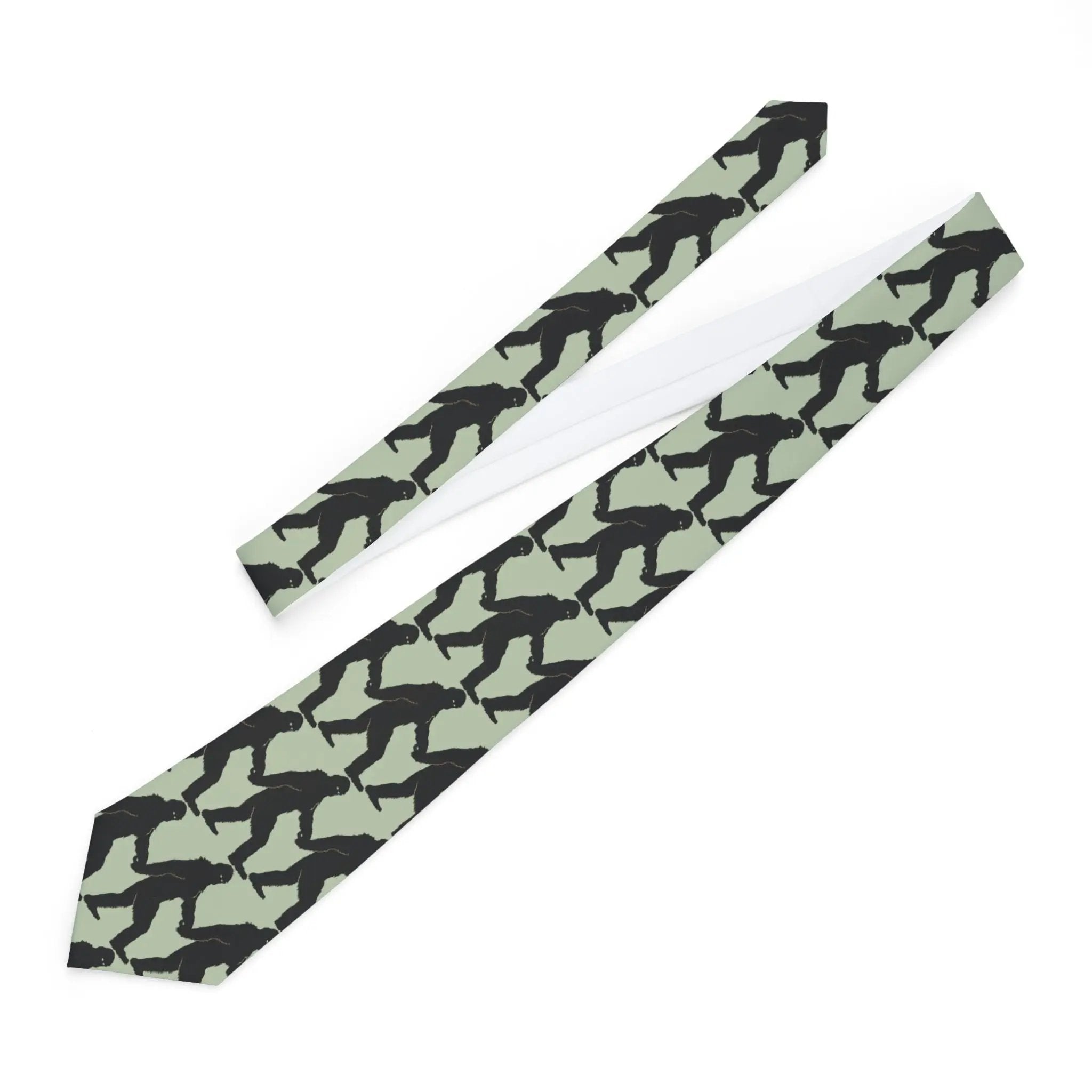 Necktie with black bigfoot silhouette pattern on a light green background