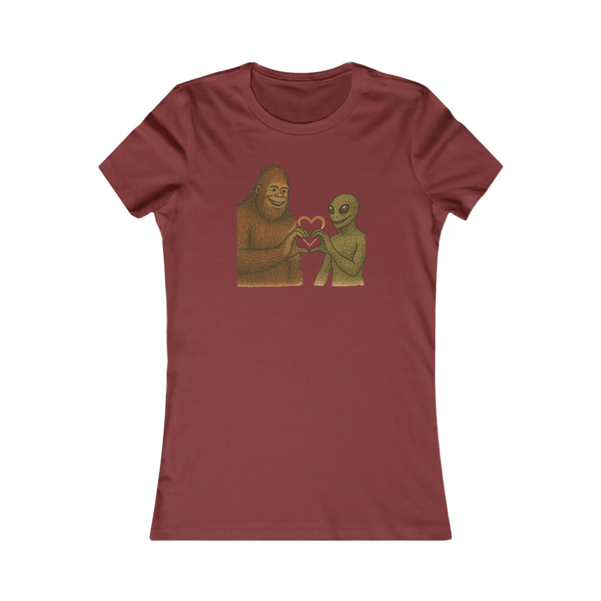 Maroon t-shirt with a graphic of a bigfoot and an alien holding hands making a heart symbol on a white background