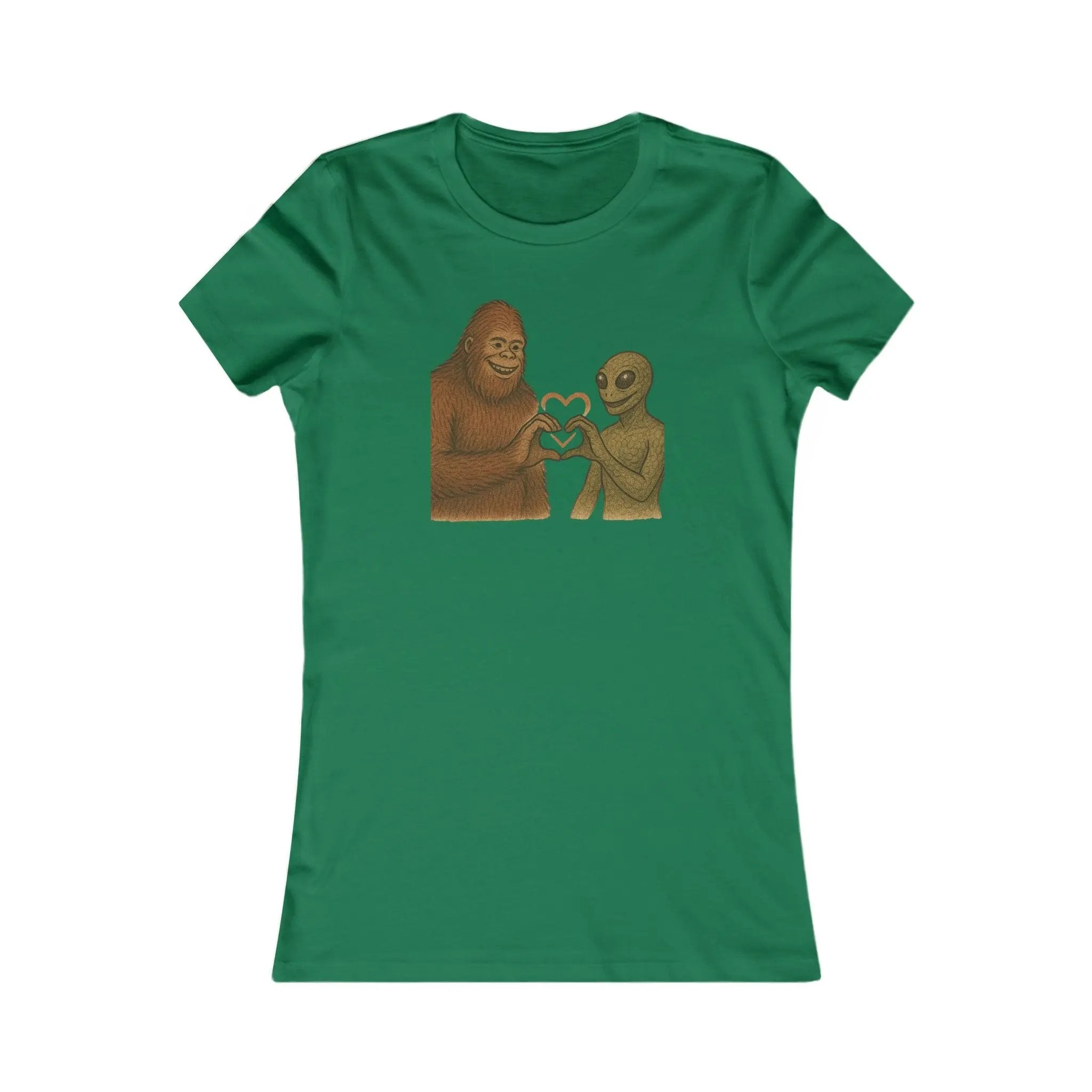 Green t-shirt with a graphic of a bigfoot and an alien holding hands making a heart symbol on a white background