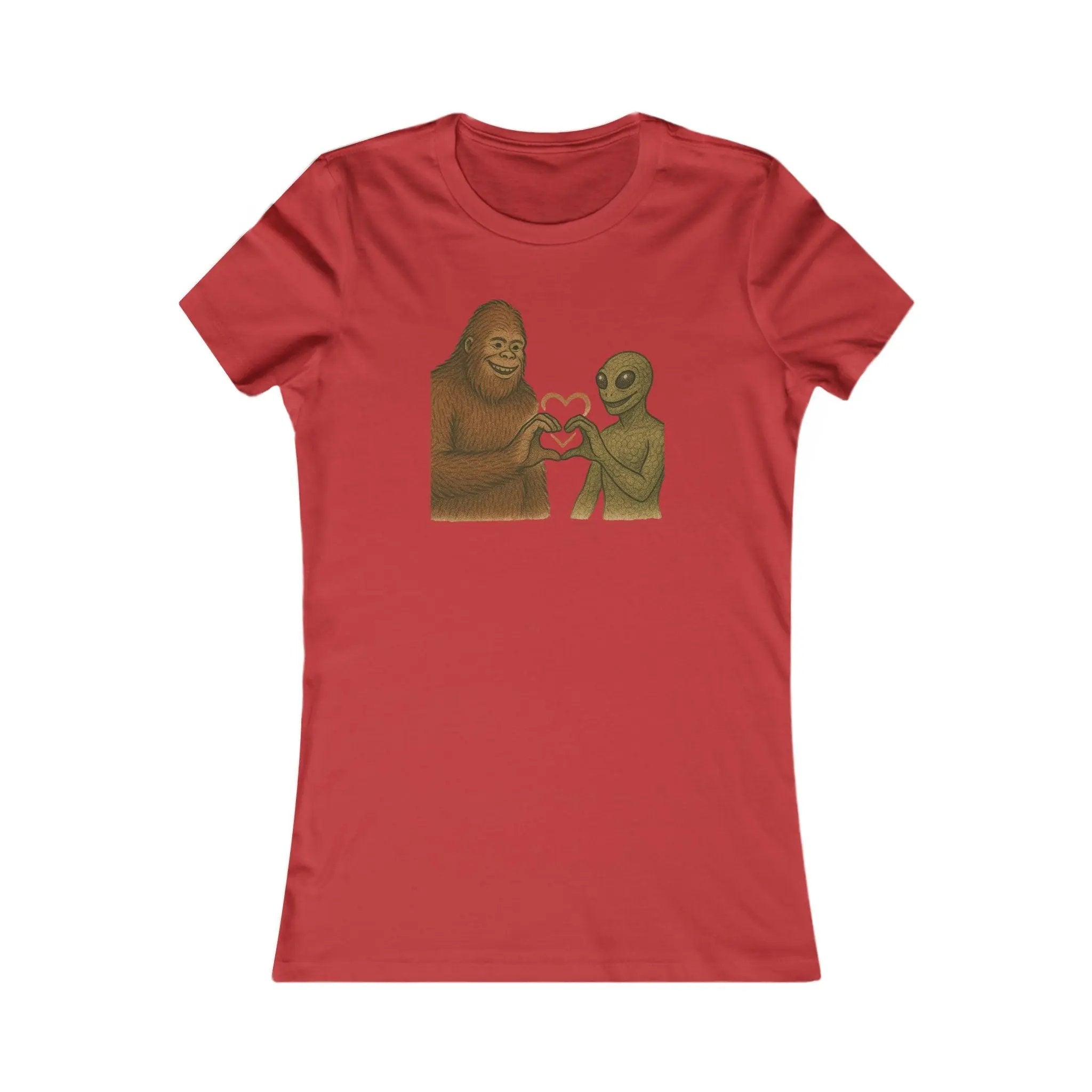 Red t-shirt with a graphic of a bigfoot and an alien holding hands making a heart symbol on a white background
