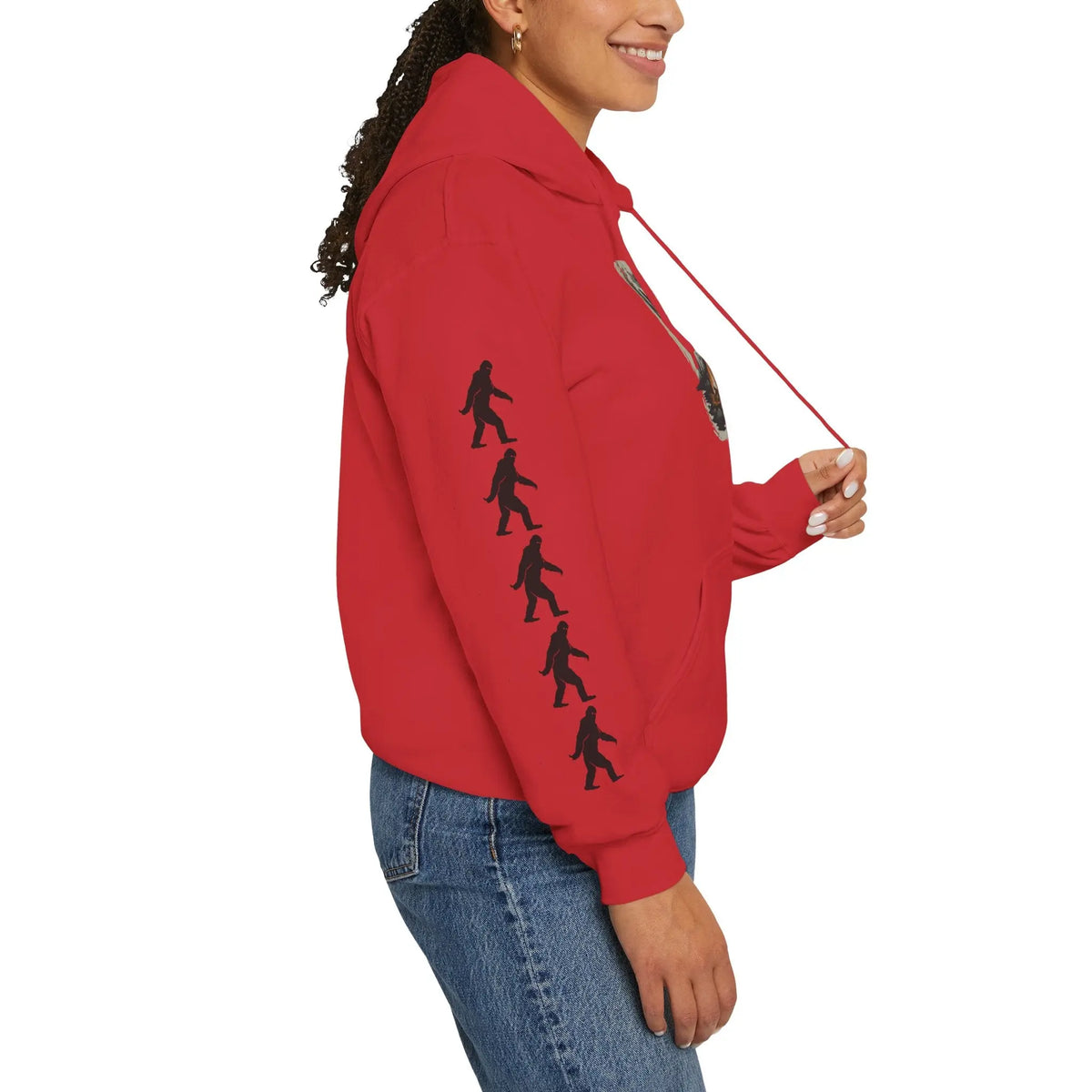 Person wearing a red hoodie with black bigfoot silhouette designs on right sleeve on a white background