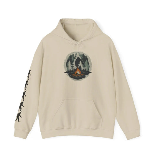 Beige hoodie with a graphic of a forest and campfire and black bigfoot silhouettes on the right sleeve on a white background on a white background