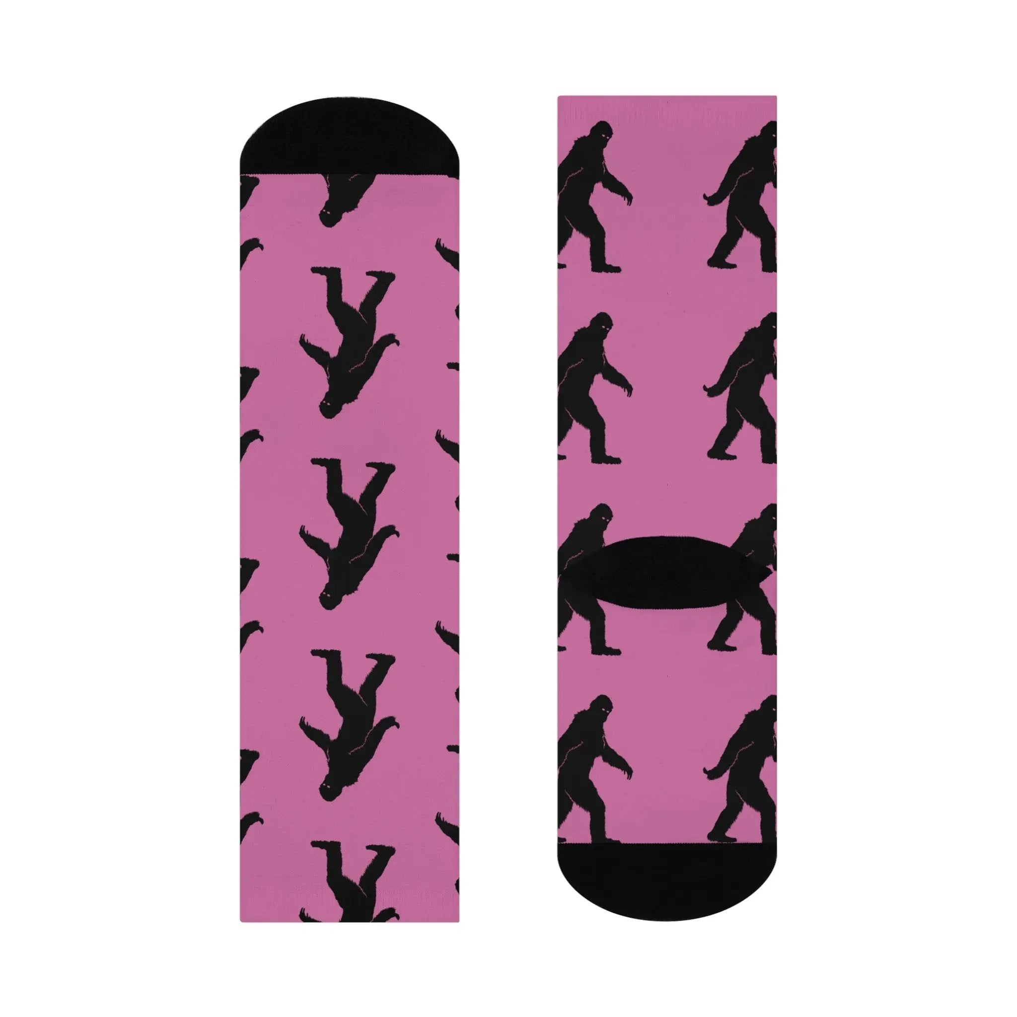 Pink socks with black bigfoot silhouette pattern on a white background