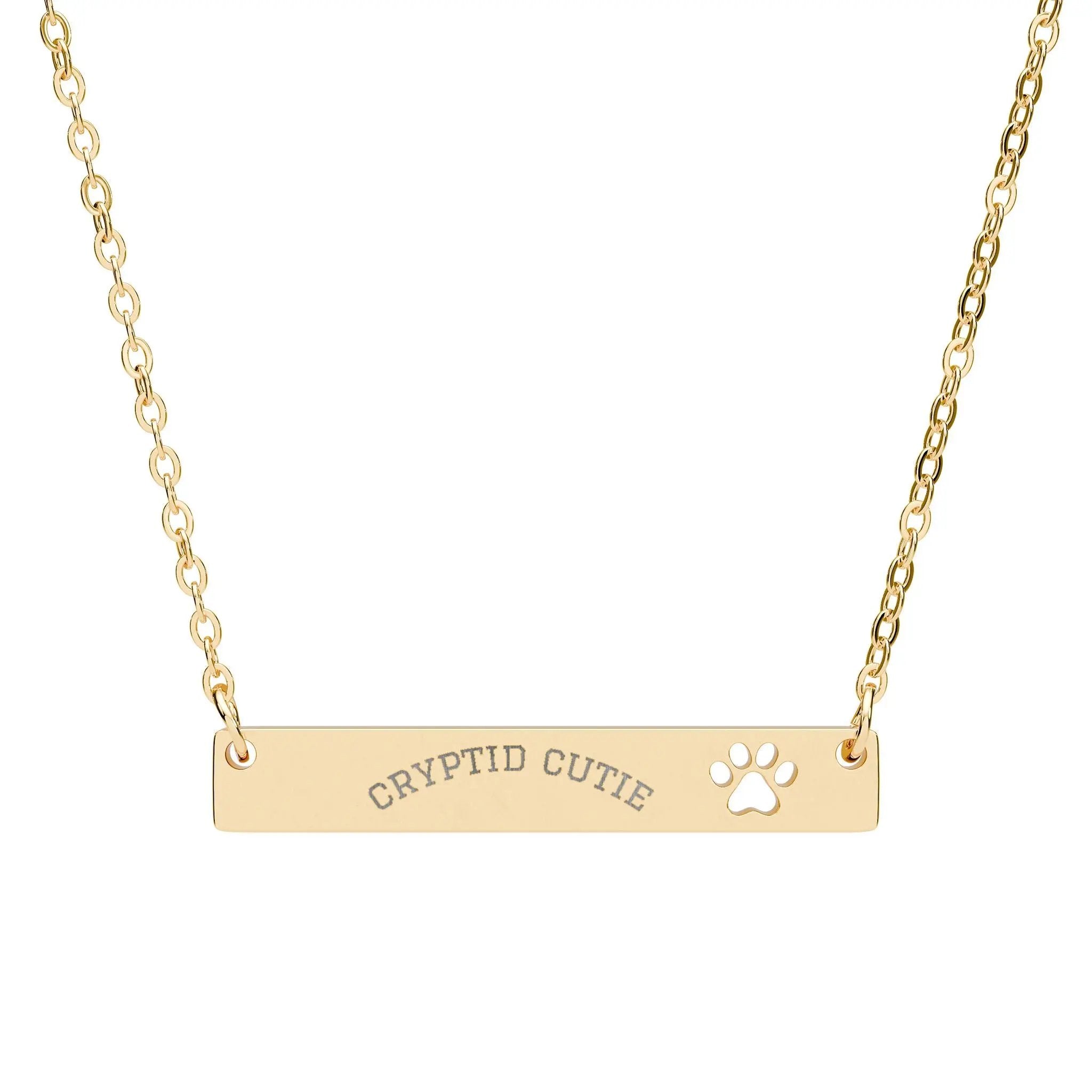 Gold necklace with 'CRYPTID CUTIE' and paw print on a white background