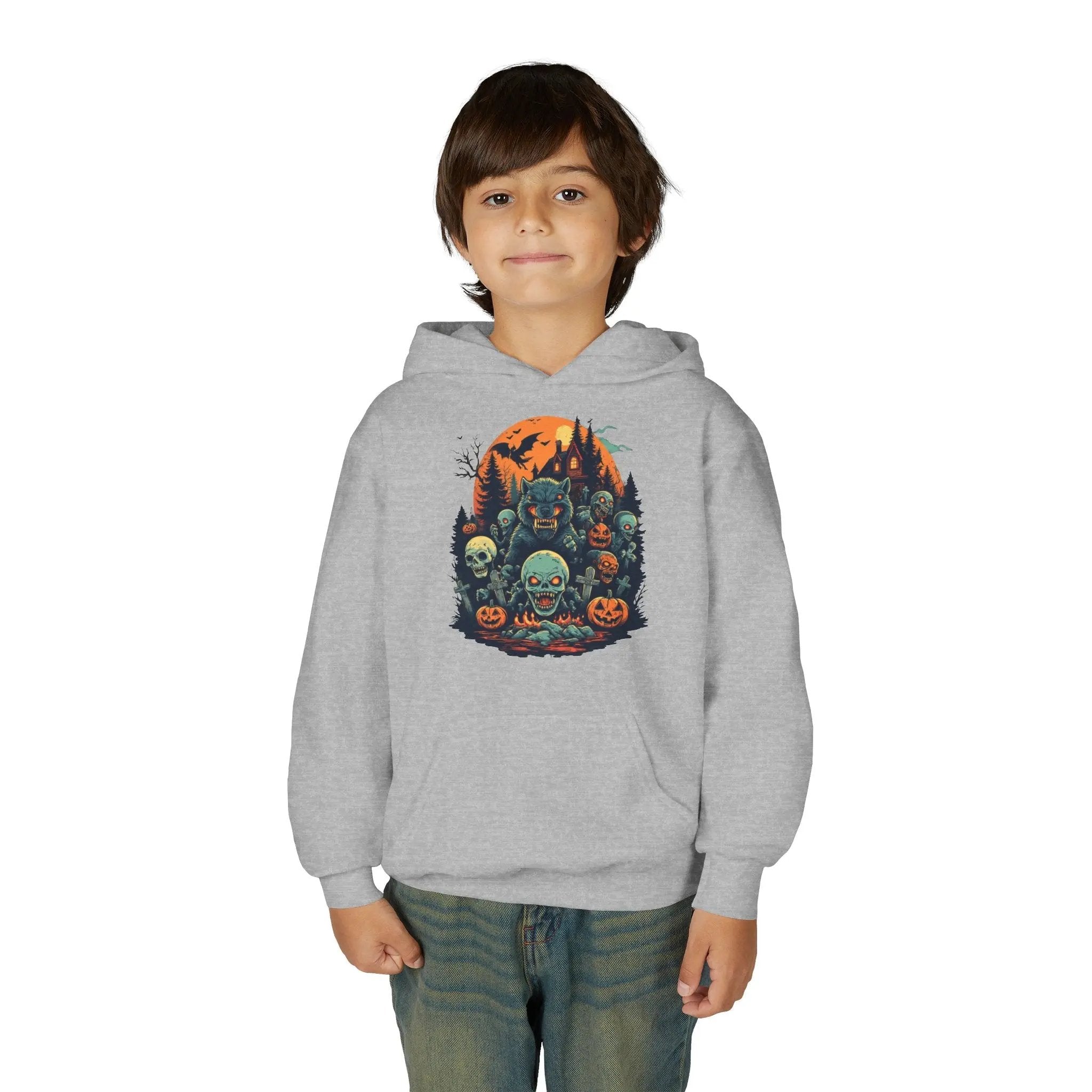 Child wearing a gray hoodie with a colorful Halloween graphic design of werewolves, zombies, and other cryptids on a white background