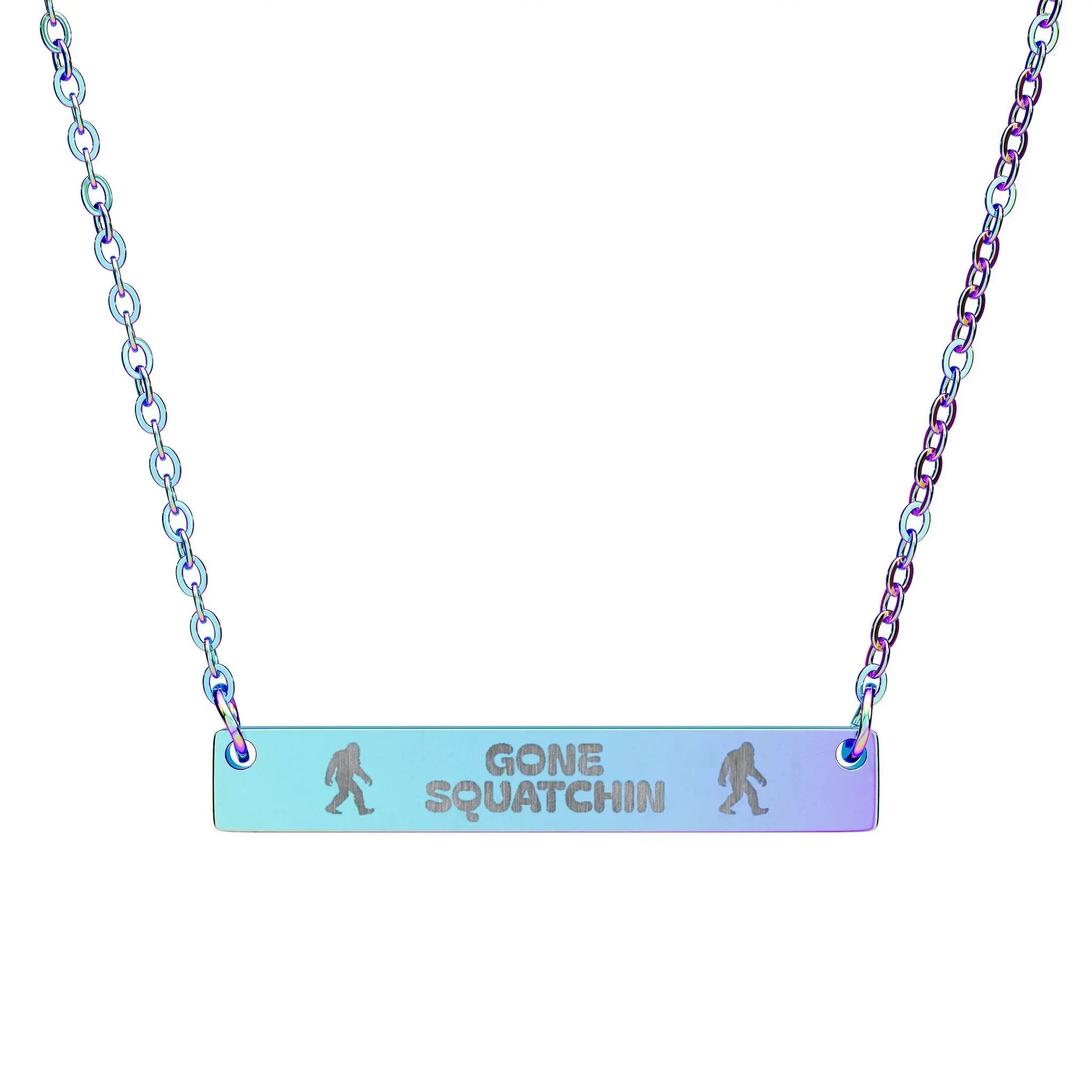 Necklace with 'Gone Squatchin' rainbow coated bar pendant and chain on a white background