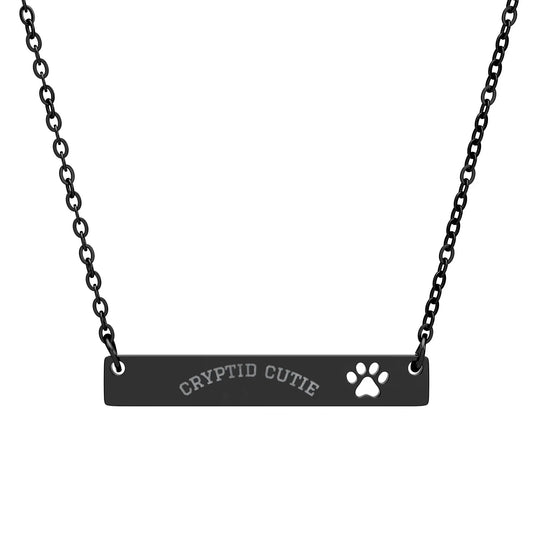 Black necklace with 'CRYPTID CUTIE' and paw print on a white background