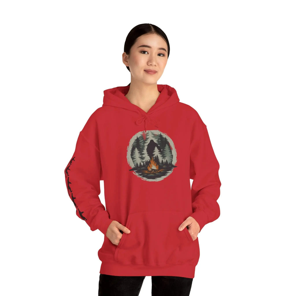Person wearing a red hoodie with a nature graphic and black bigfoot silhouettes on the right sleeve on a white background on a white background