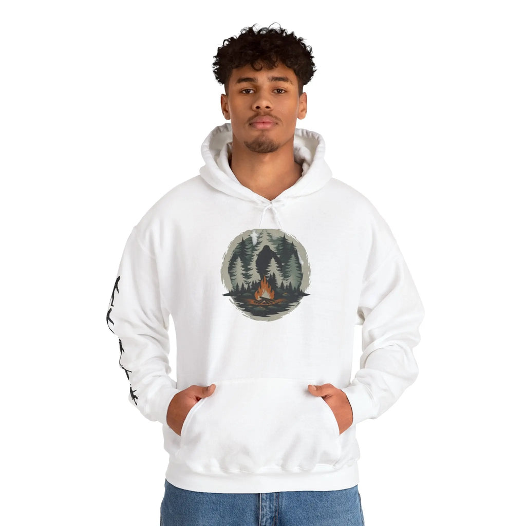 Person wearing a white hoodie with a nature graphic and black bigfoot silhouettes on the right sleeve on a white background on a white background