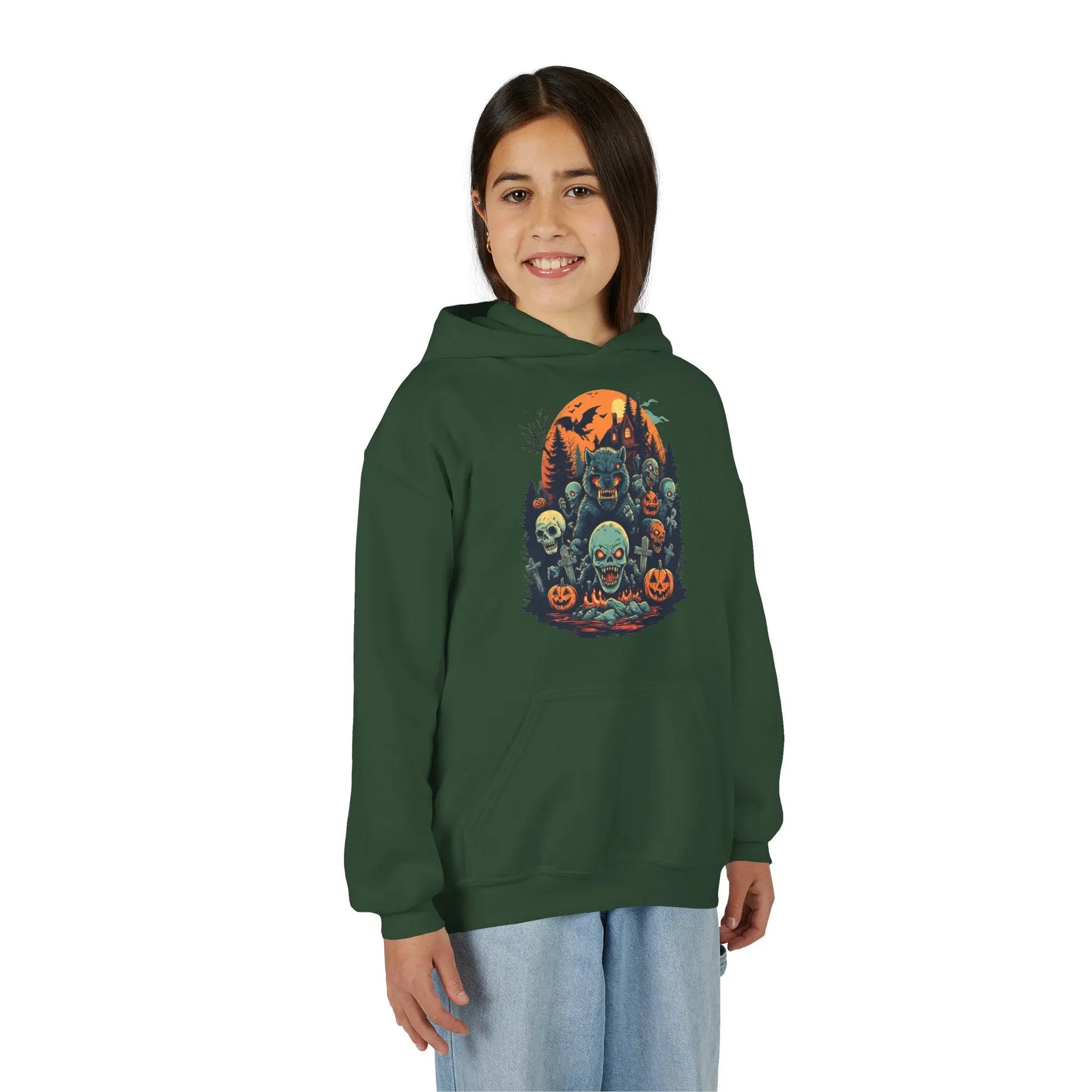 Older child wearing a green hoodie with a colorful Halloween graphic design of werewolves, zombies, and other cryptids on a white background