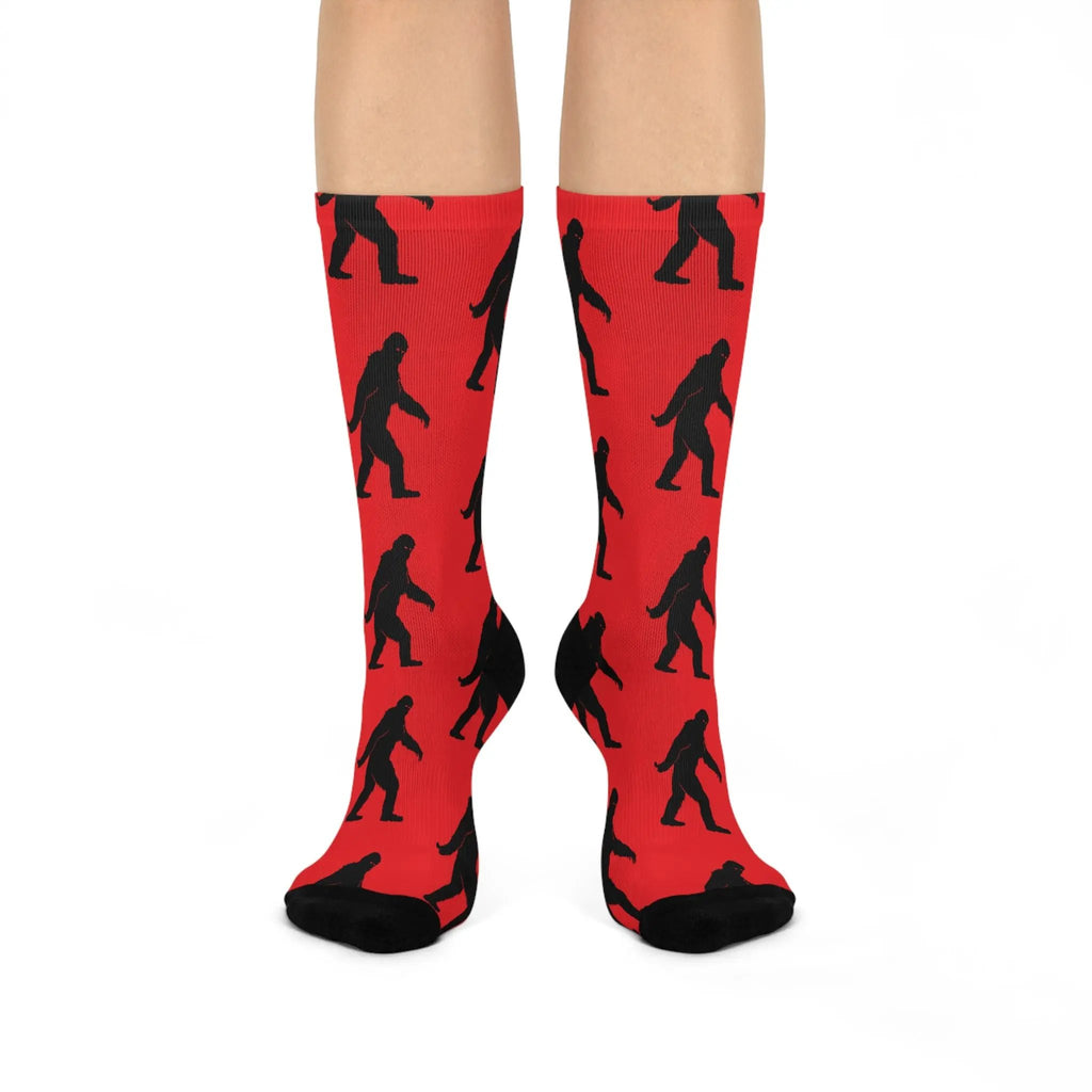 Red socks with black Bigfoot patterns on a white background
