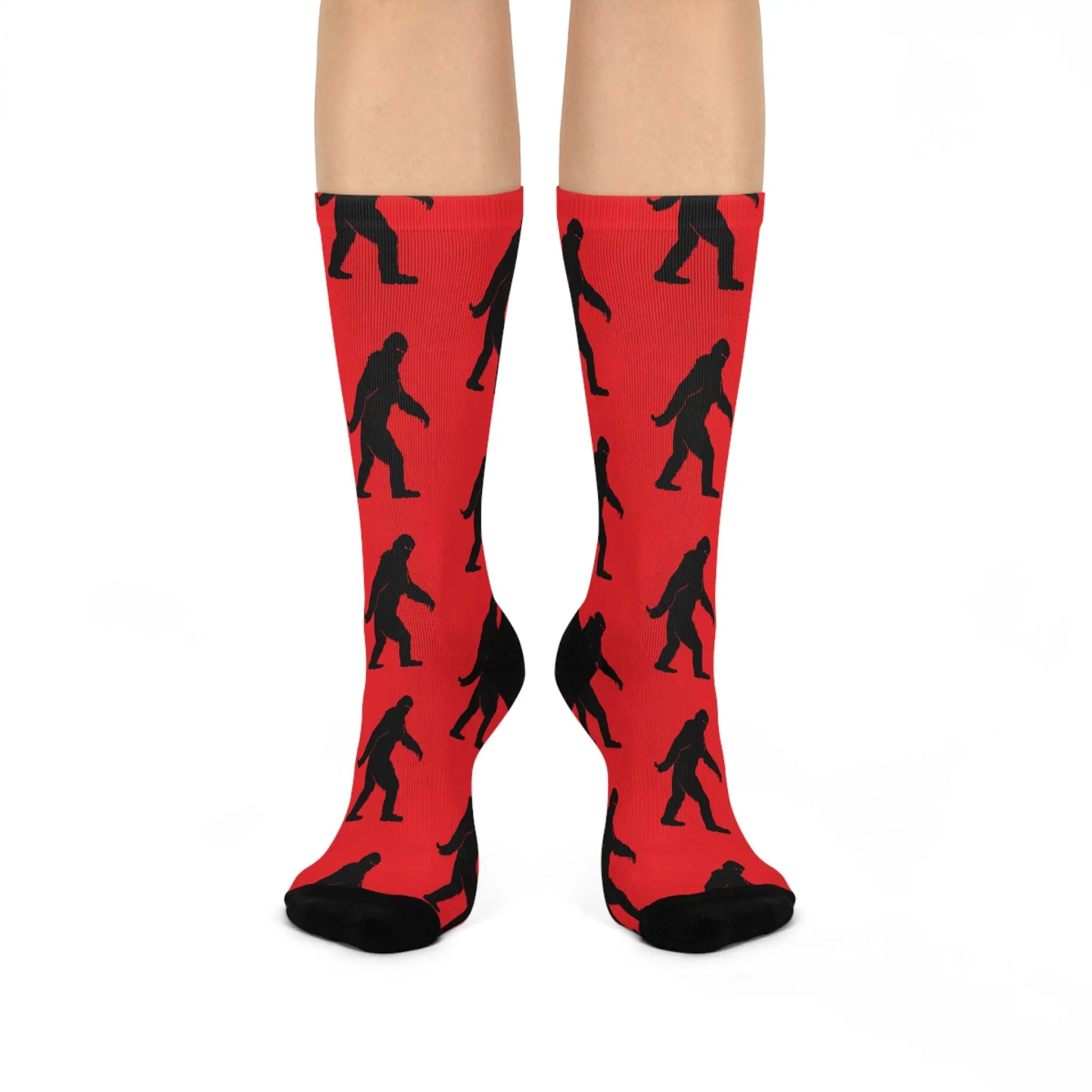 Red socks with black Bigfoot patterns on a white background