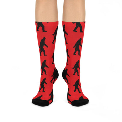 Red socks with black Bigfoot patterns on a white background