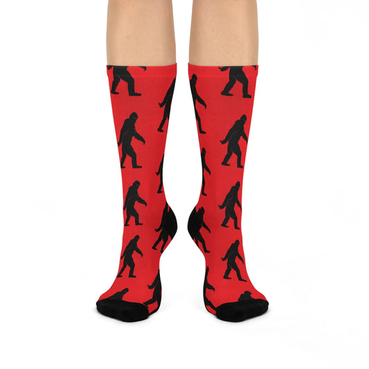 Red socks with black Bigfoot patterns on a white background