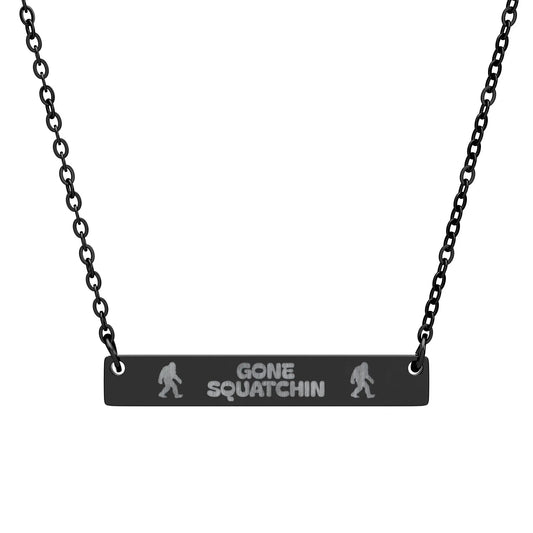 Necklace with 'Gone Squatchin' black pendant on a black chain against a white background