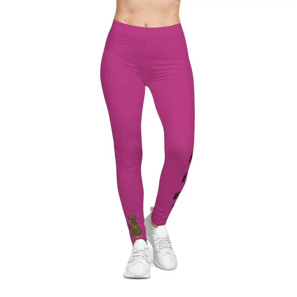 Person wearing Pink leggings with bigfoot and alien heart hands on right leg and bigfoot print designs on left leg on a white background
