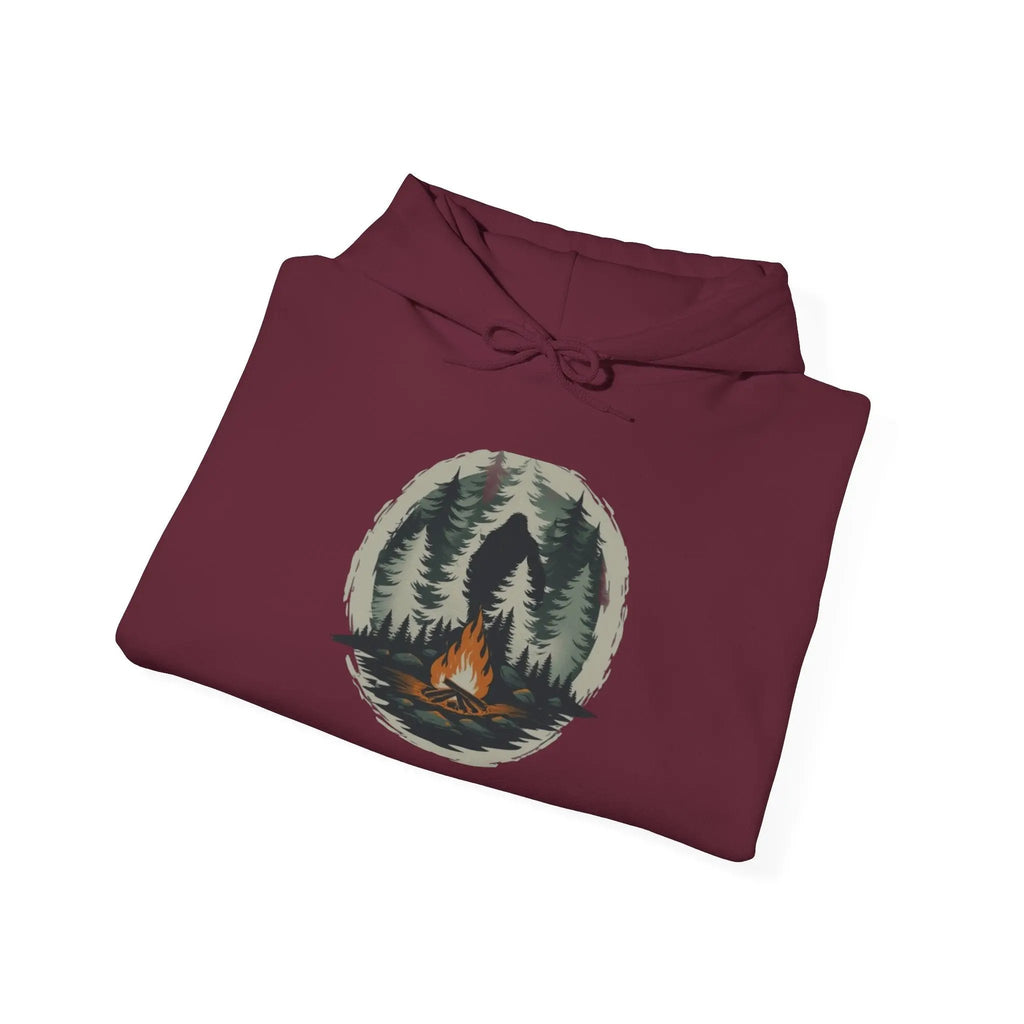 Folded maroon hoodie with nature graphic on a white background