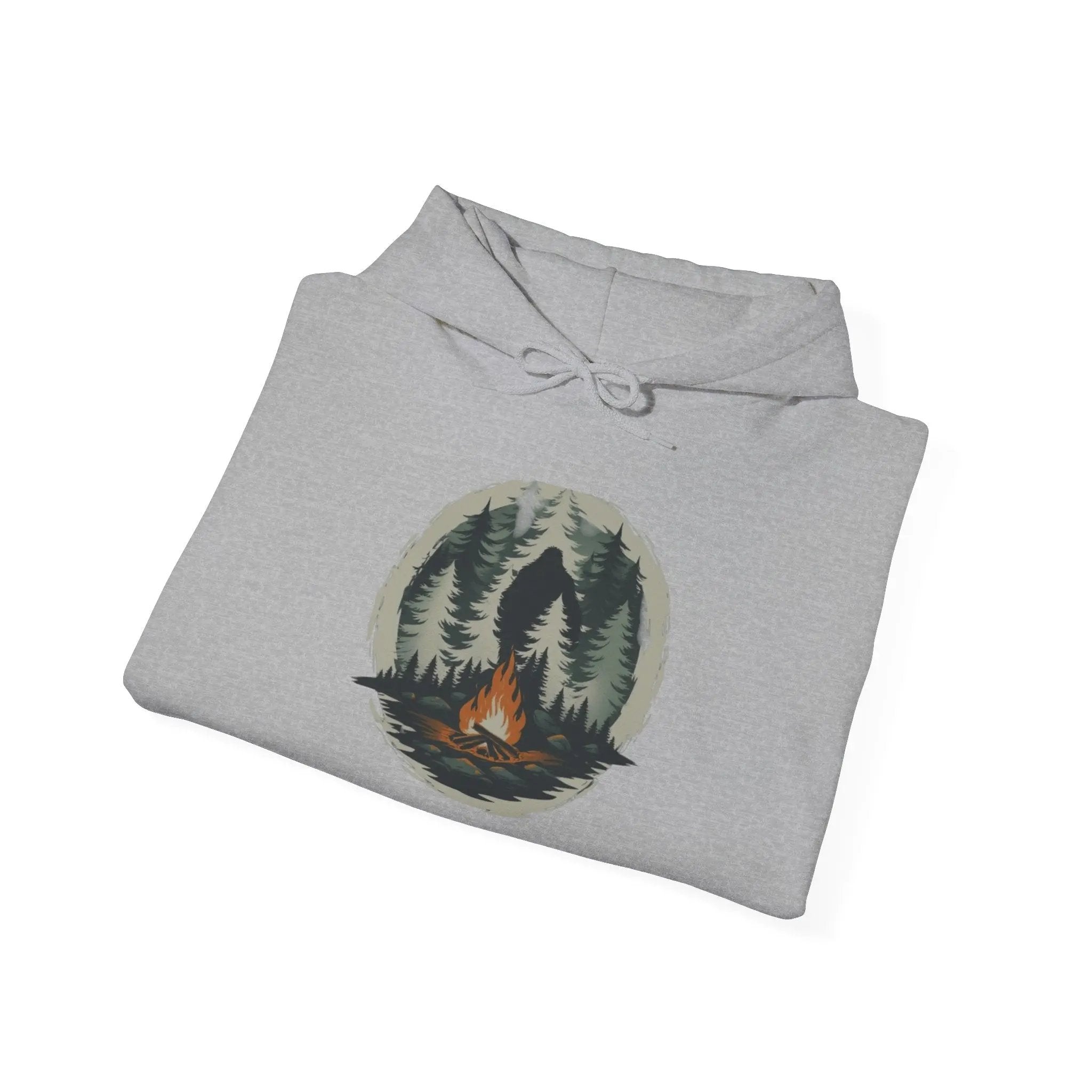 Folded gray hoodie with a nature-themed graphic on a white background