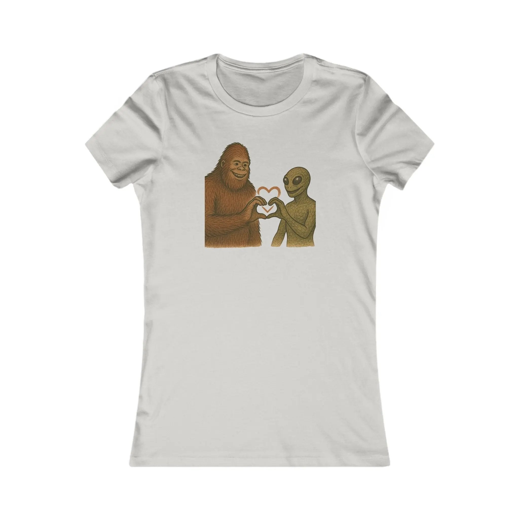 White t-shirt with a graphic of a bigfoot and an alien holding hands making a heart symbol on a white background