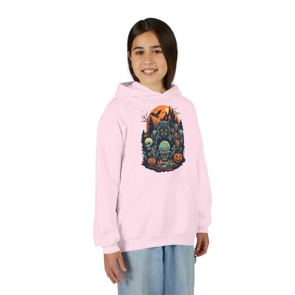 Older child wearing a pink hoodie with a colorful Halloween graphic design of werewolves, zombies, and other cryptids on a white background