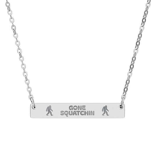 Silver necklace with 'Gone Squatchin' pendant on a white background
