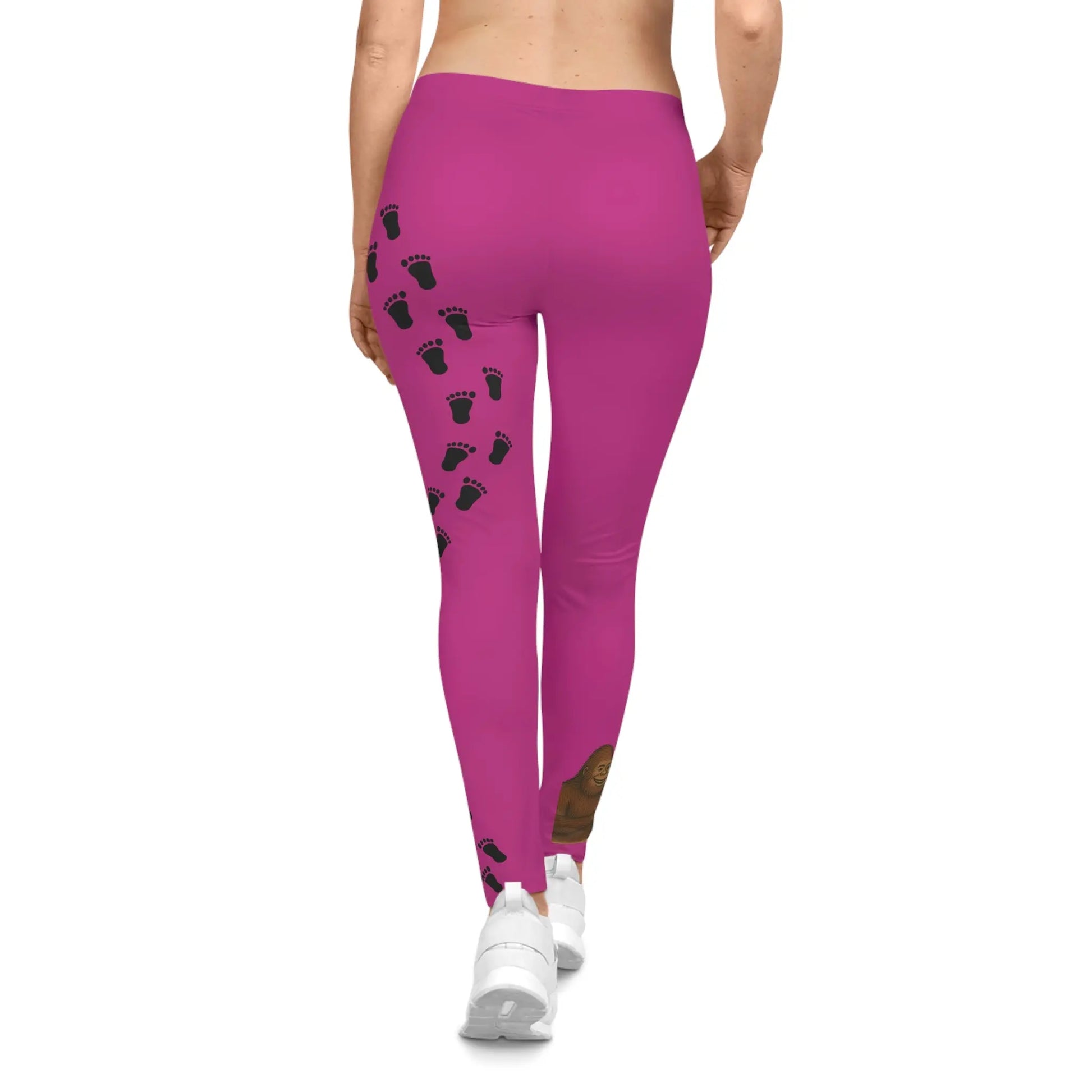 Back view of person wearing Pink leggings with bigfoot and alien heart hands on right leg and bigfoot print designs on left leg on a white background