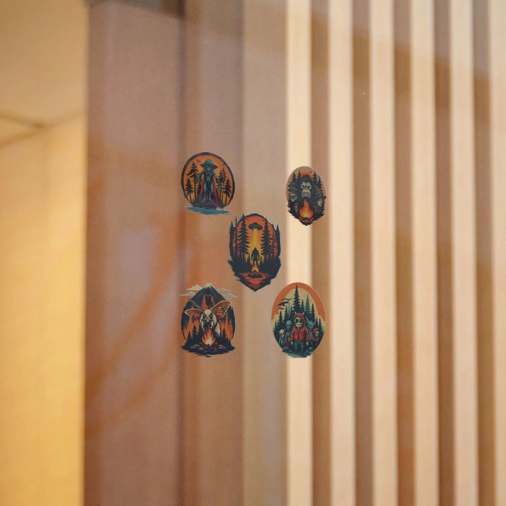 Five illustrated stickers on a window with a beige curtain in the background