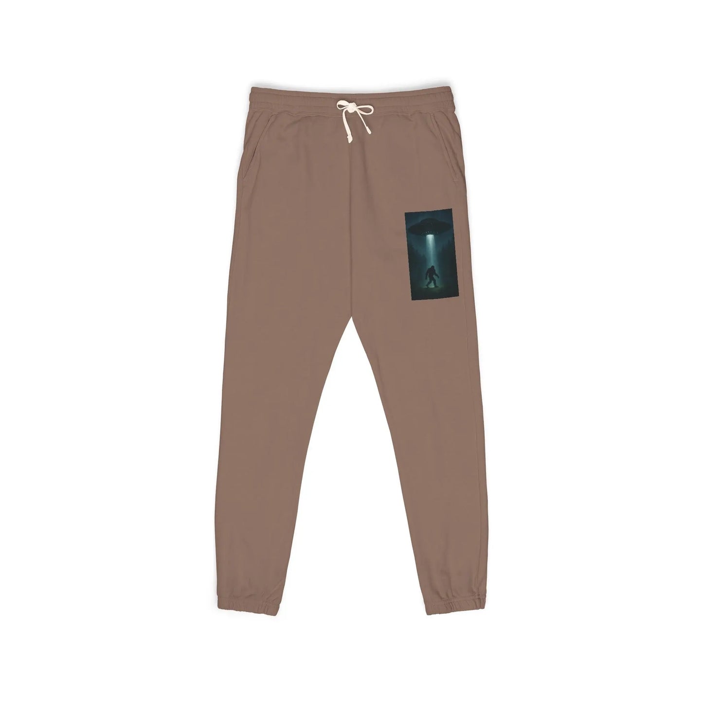 Brown sweatpants with a small graphic of a UFO with a beam of light on a bigfoot silhouette on the left leg on a white background