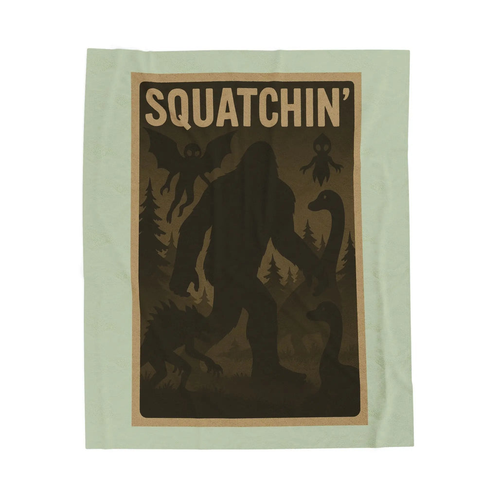 Light green fleece blanket with 'Squatchin' text across the top with silhouettes of bigfoot, loch Ness, werewolf, mothman, and an alien.