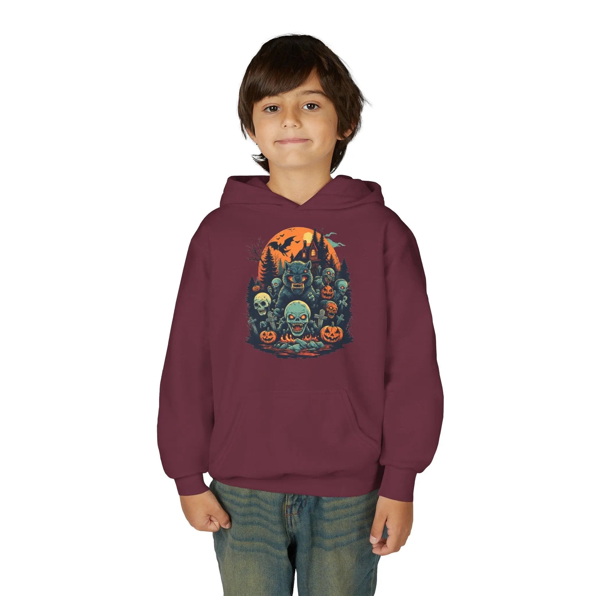 Child wearing a maroon hoodie with a colorful Halloween graphic design of werewolves, zombies, and other cryptids on a white background