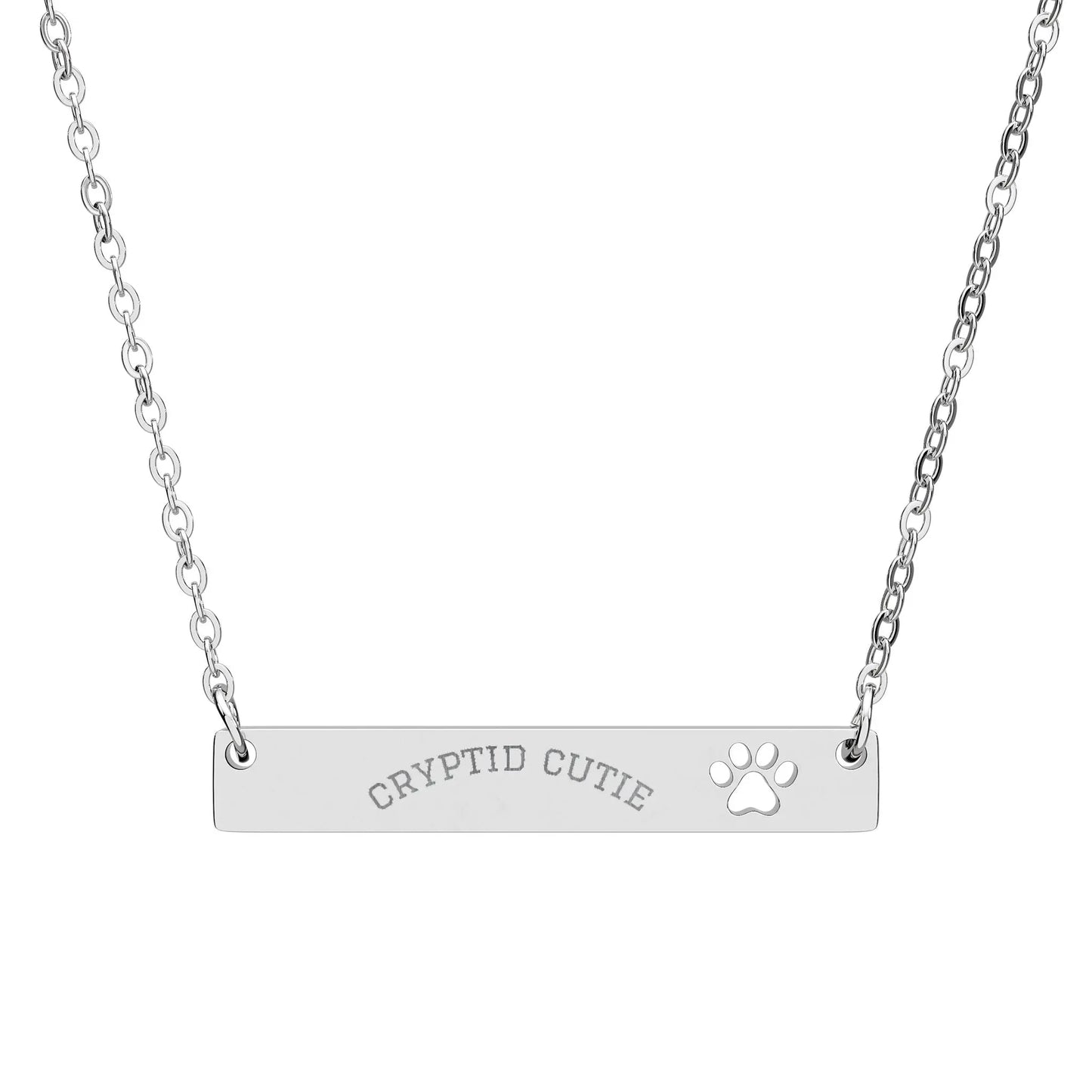 Silver necklace with 'CRYPTID CUTIE' and paw print on a white background