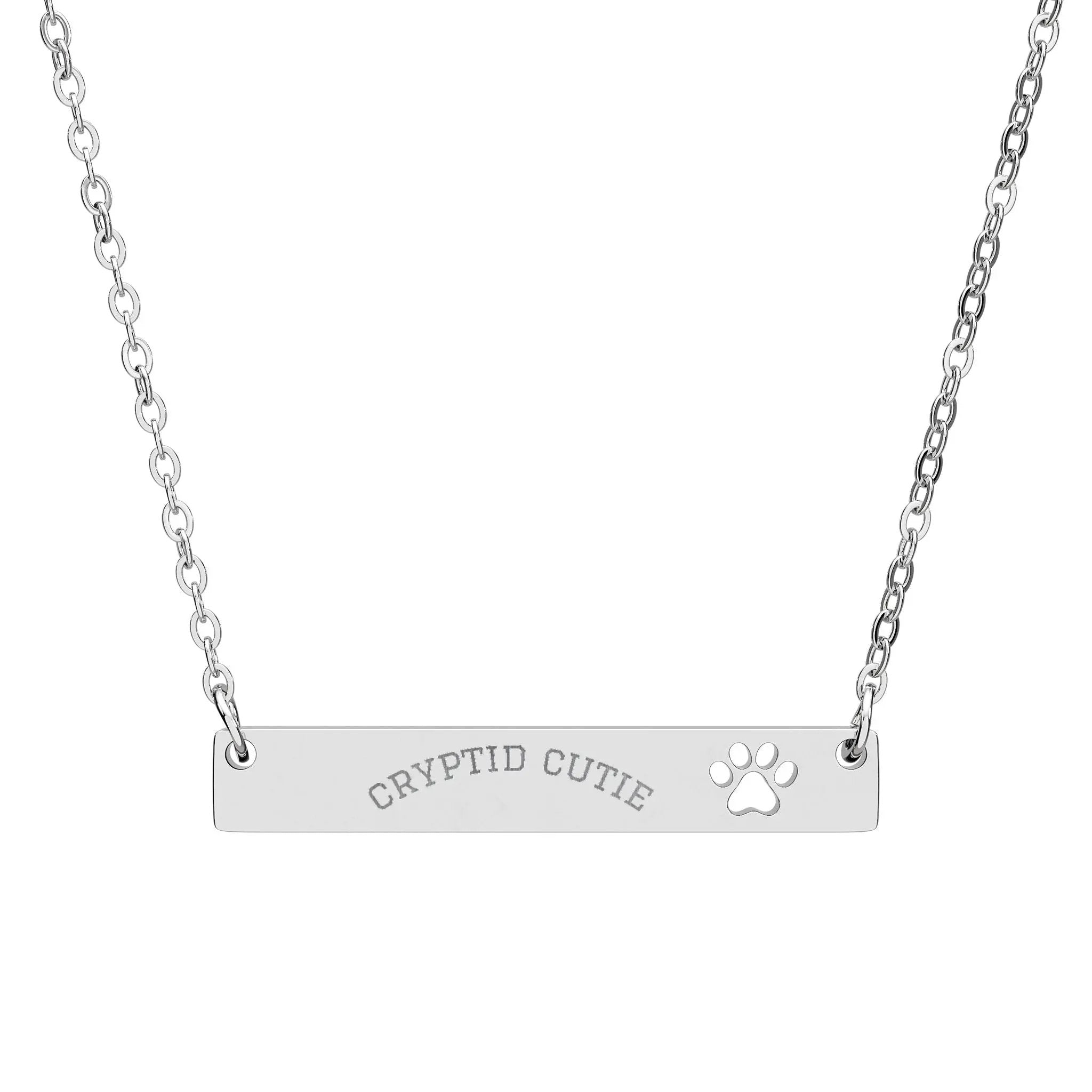 Silver necklace with 'CRYPTID CUTIE' and paw print on a white background