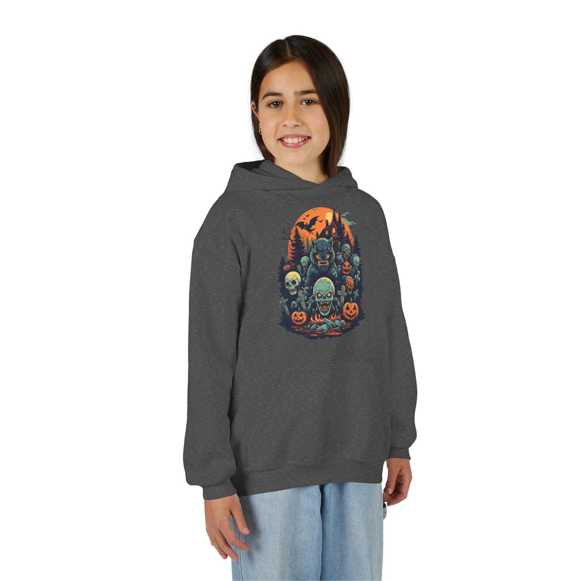 Older child wearing a dark gray hoodie with a colorful Halloween graphic design of werewolves, zombies, and other cryptids on a white background