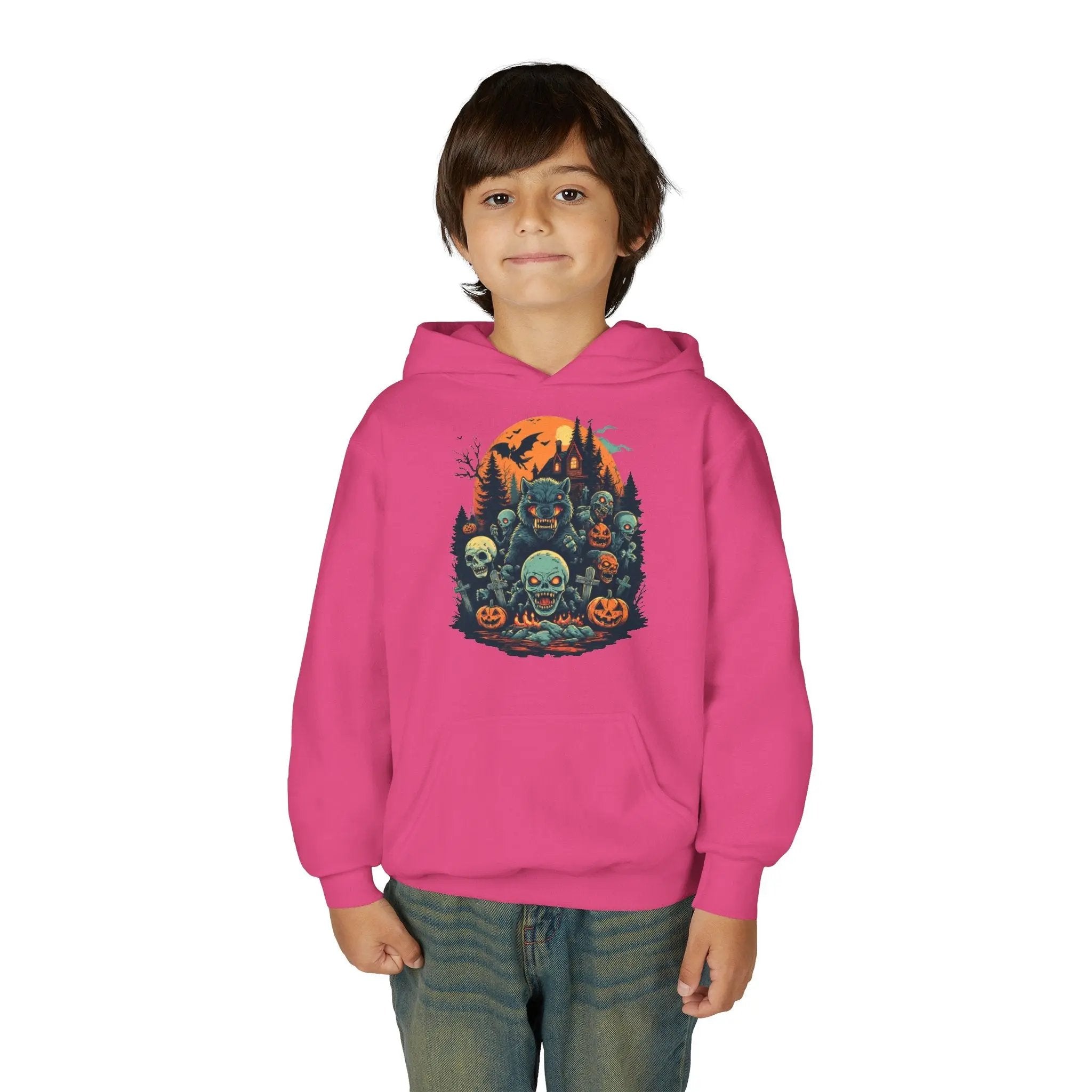Child wearing a pink hoodie with a colorful Halloween graphic design of werewolves, zombies, and other cryptids on a white background