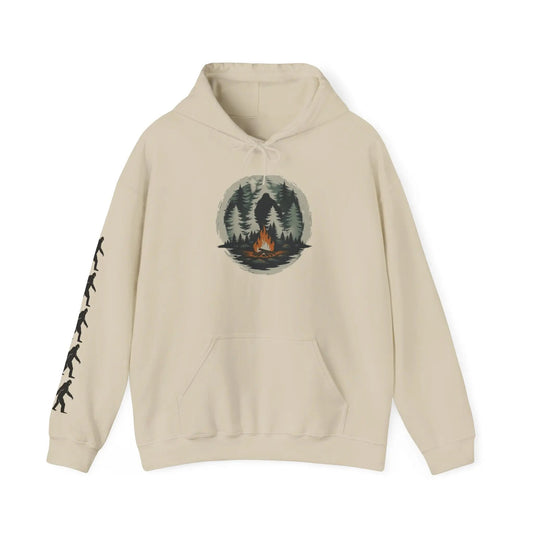 Beige hoodie with a graphic of a forest and campfire and black bigfoot silhouettes on the right sleeve on a white background on a white background