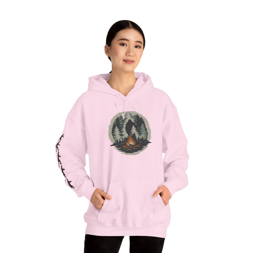Person wearing a pink hoodie with a nature graphic and black bigfoot silhouettes on the right sleeve on a white background on a white background