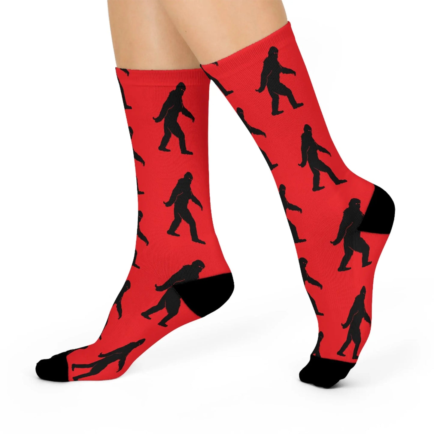 Red socks with black bigfoot silhouette pattern on a white background