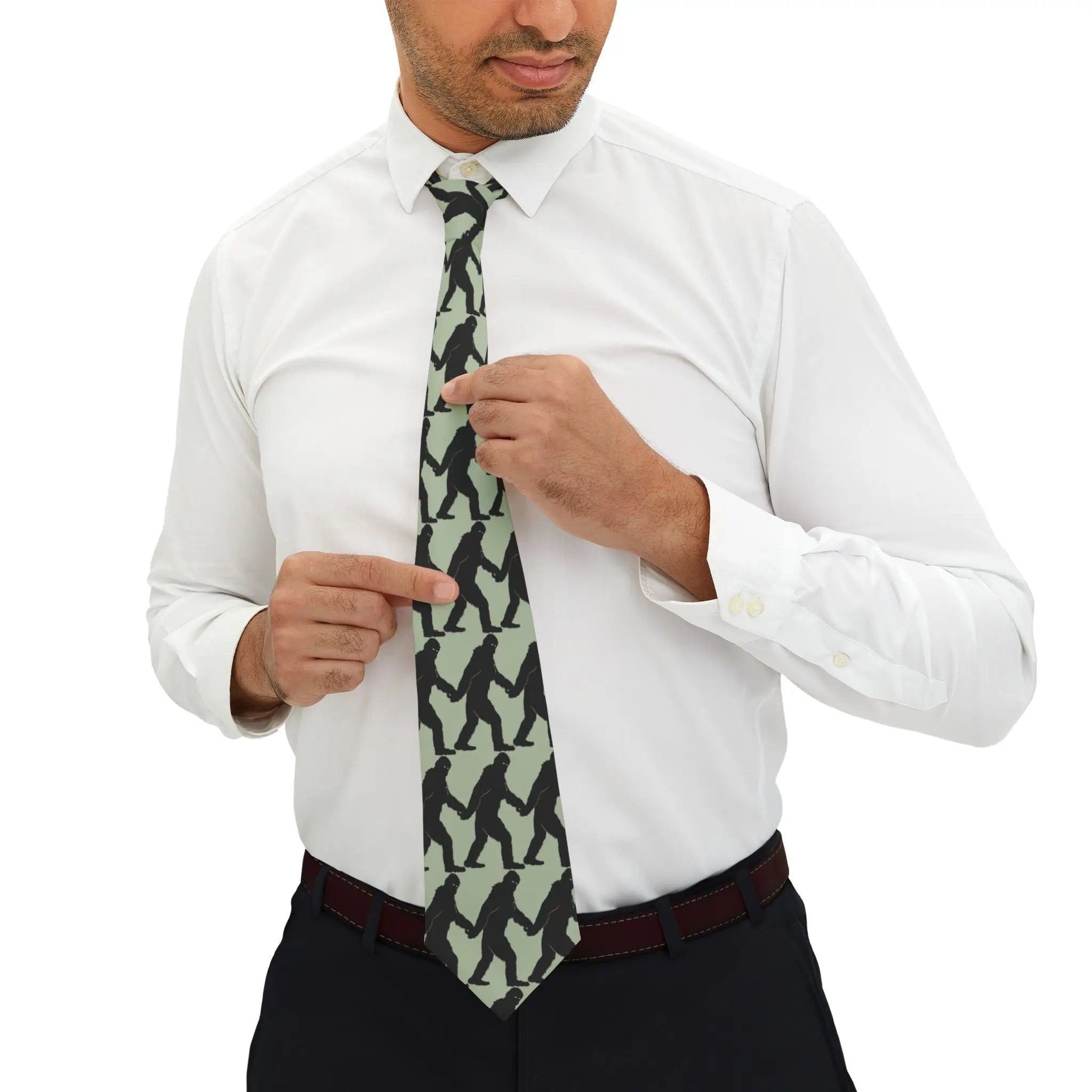 Man adjusting a patterned tie on a white shirt with a white background