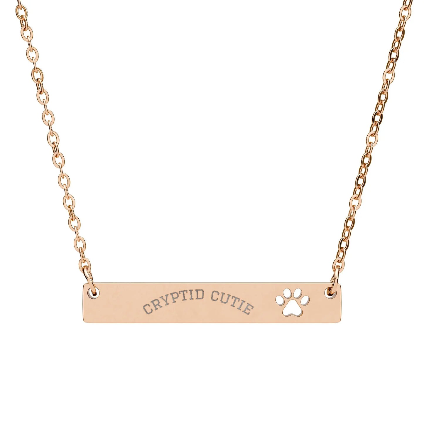 Rose gold necklace with 'CRYPTID CUTIE' and paw print on a white background