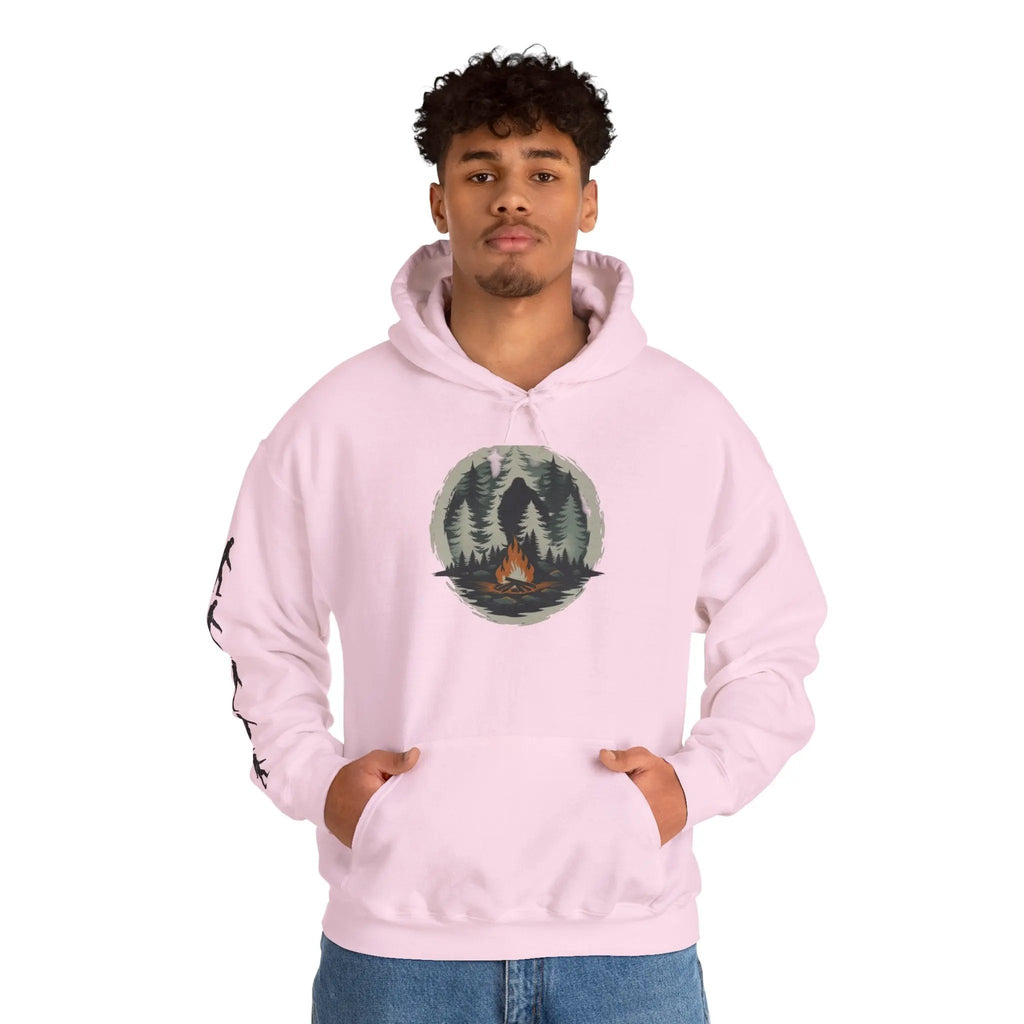 Person wearing a pink hoodie with a nature graphic and black bigfoot silhouettes on the right sleeve on a white background on a white background