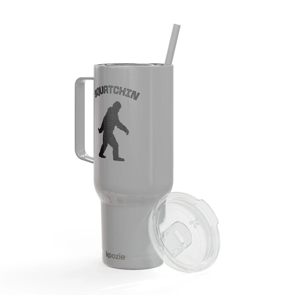 Gray tumbler with 'Squatchin' design and handle on a white background